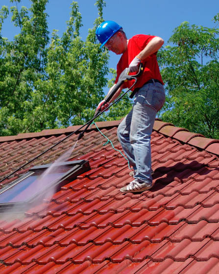 pressure cleaning technician on roof